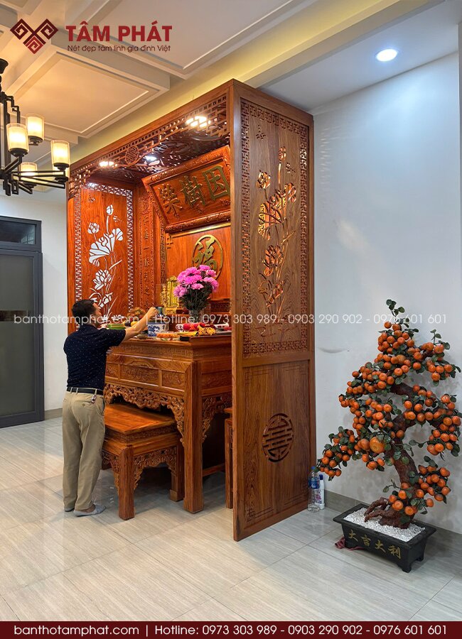 Vách ngăn gỗ hương chắc chắn, thiết kế CNC họa tiết hoa sen tinh xảo, tăng sự kín đáo, tạo điểm nhấn thẩm mỹ nổi bật cho phòng thờ.